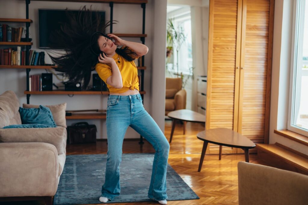 Young woman dancing in her living room